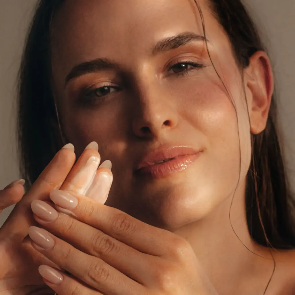 Entspannte Frau mit exklusiver Creme an den Fingern - Rosel Heim Produkte bei Claresco Cosmetic