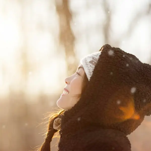 Glückliche Frau in der Winterlandschaft mit gut geschützter Haut -Claresco Cosmetic